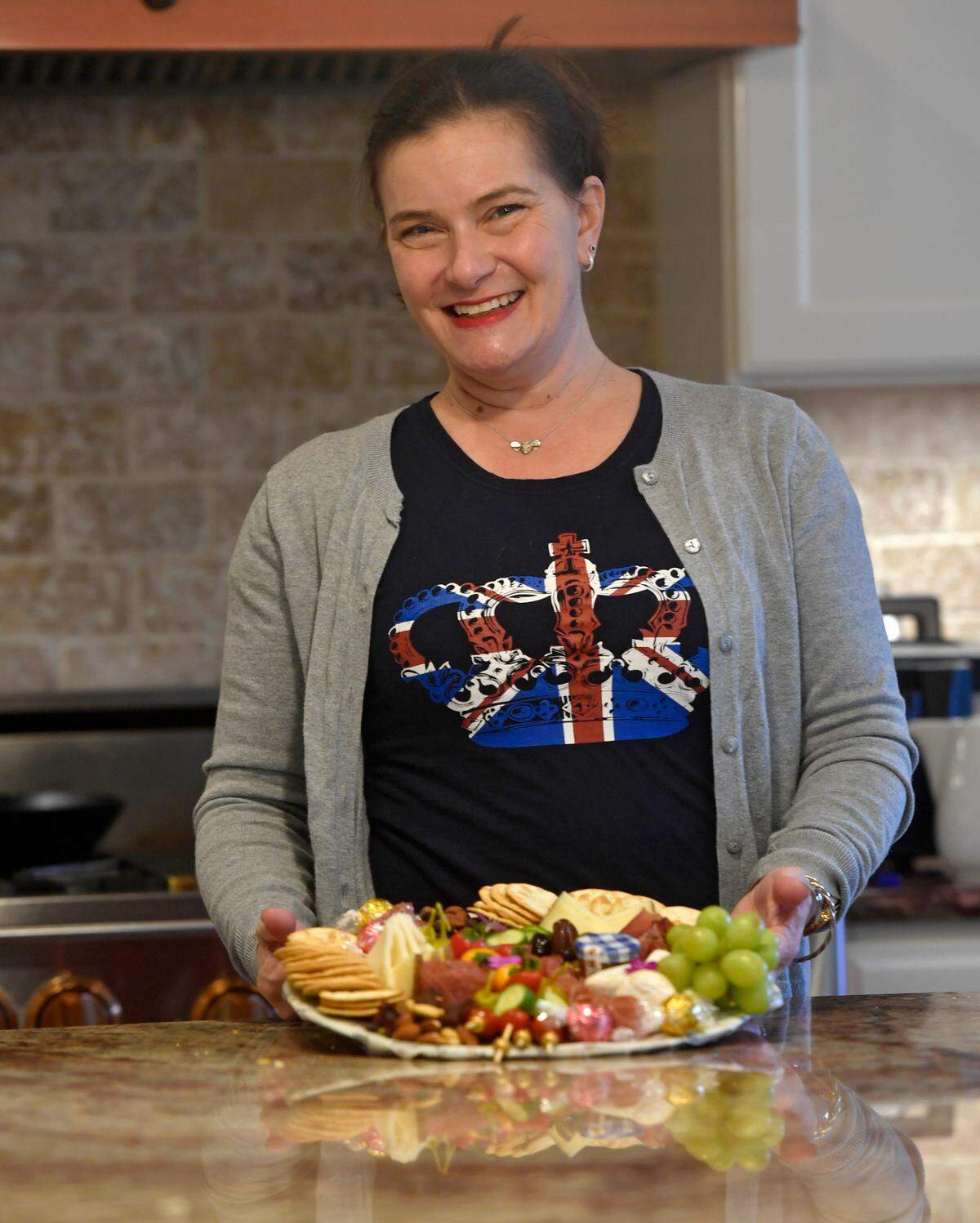Regina Brannen of The Queen’s Cheese holds one of her charcuterie plates on Thursday, Jan. 14, 2021.