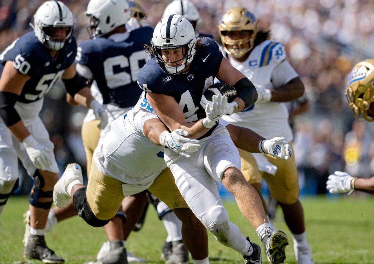 Penn State tight end Tyler Warren dodges UCLA defenders during the game on Saturday, Oct. 5, 2024 at Beaver Stadium.  