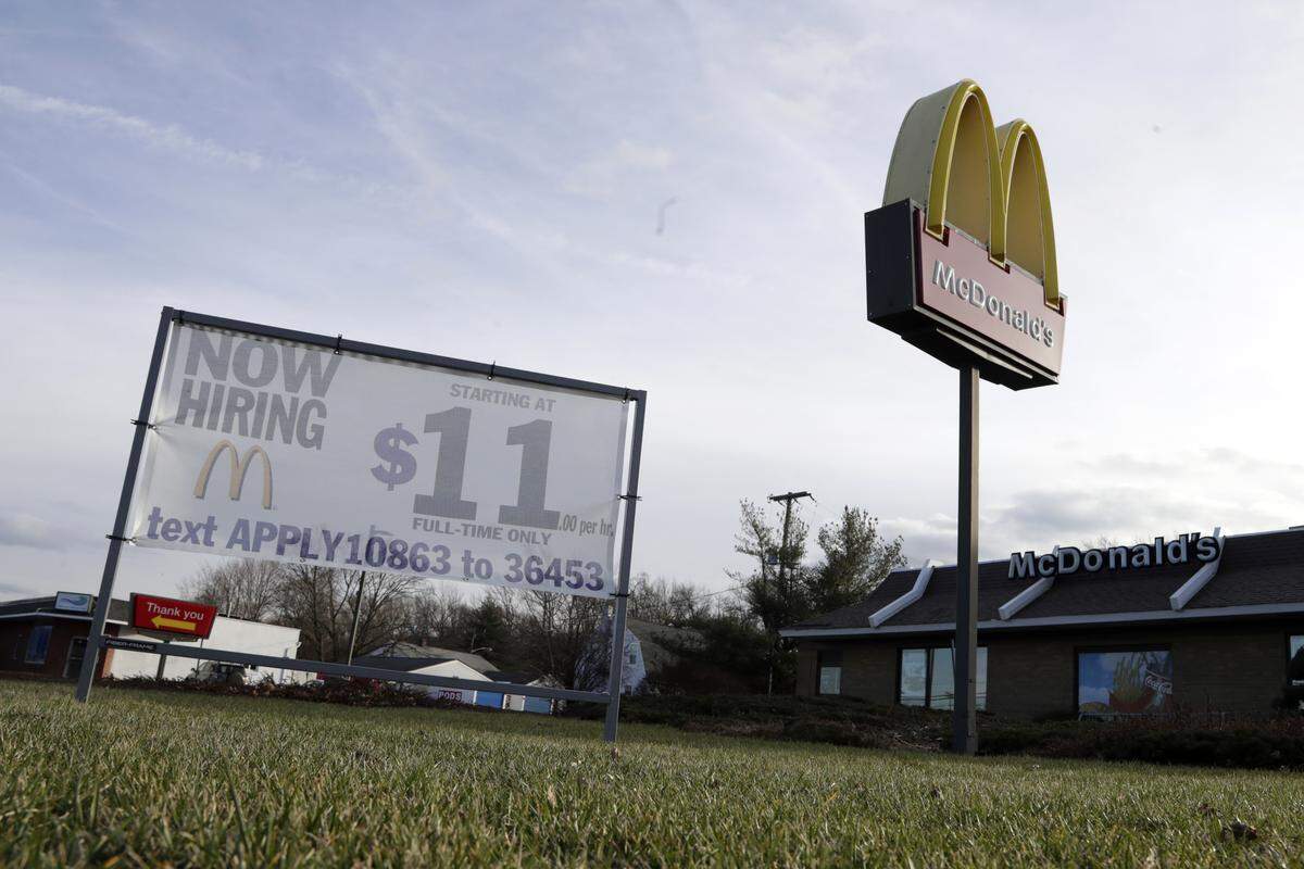 A “Now Hiring” sign is seen with a $11 per hour pay stipulation outside of a McDonald’s a restaurant, Thursday, Jan. 3, 2019, in Atlantic Highlands, N.J. (AP Photo/Julio Cortez)