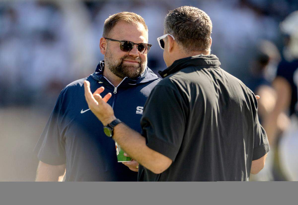 Penn State offensive coordinator Andy Kotelnicki talks to Penn State athletic director Pat Kraft before the game against UCLA on Saturday, Oct. 5, 2024 at Beaver Stadium. 
