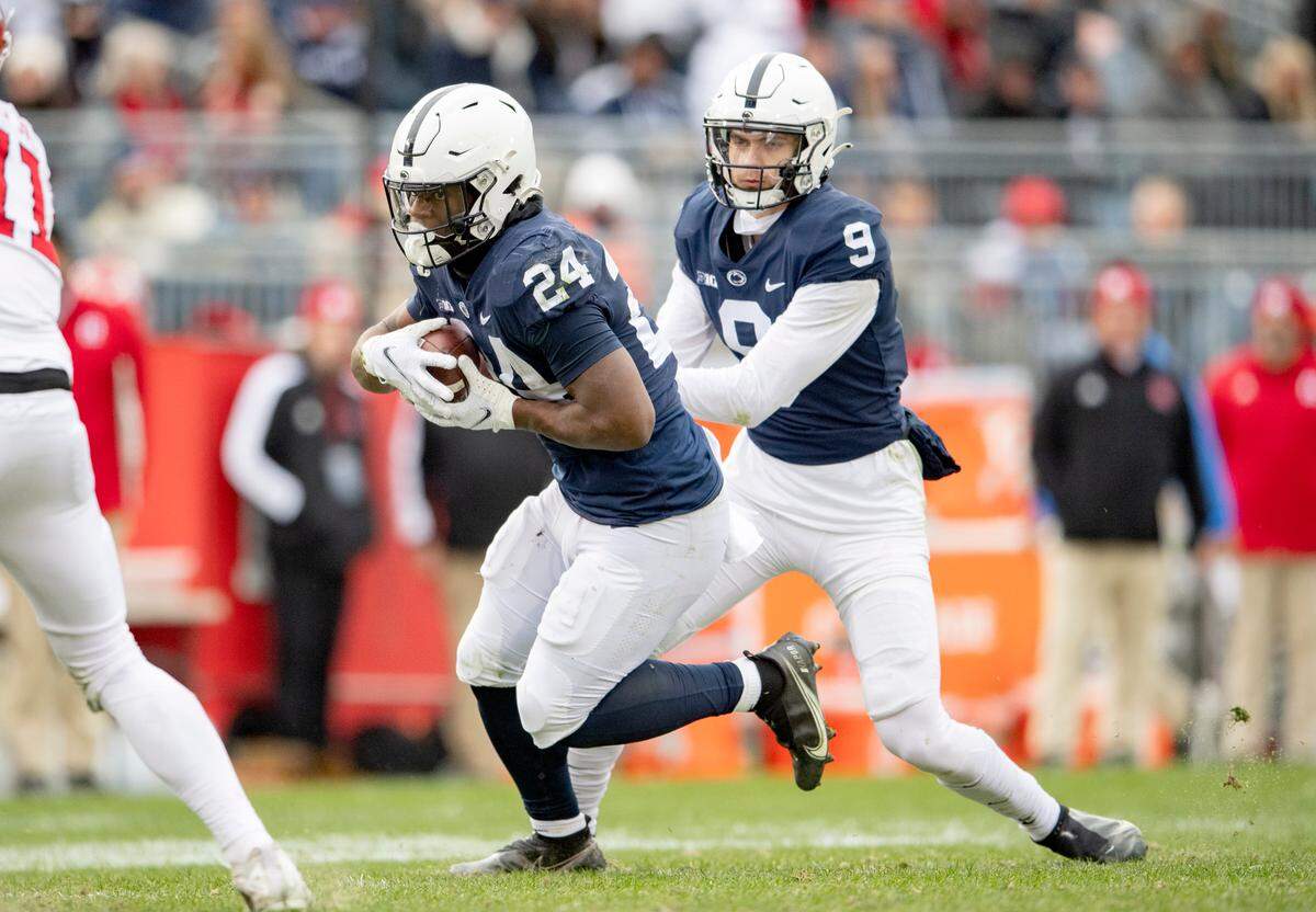 Penn State running back Keyvone Lee gets the hand off from quarterback Christian Veilleux during the game against Rutgers on Saturday, Nov. 20, 2021.
