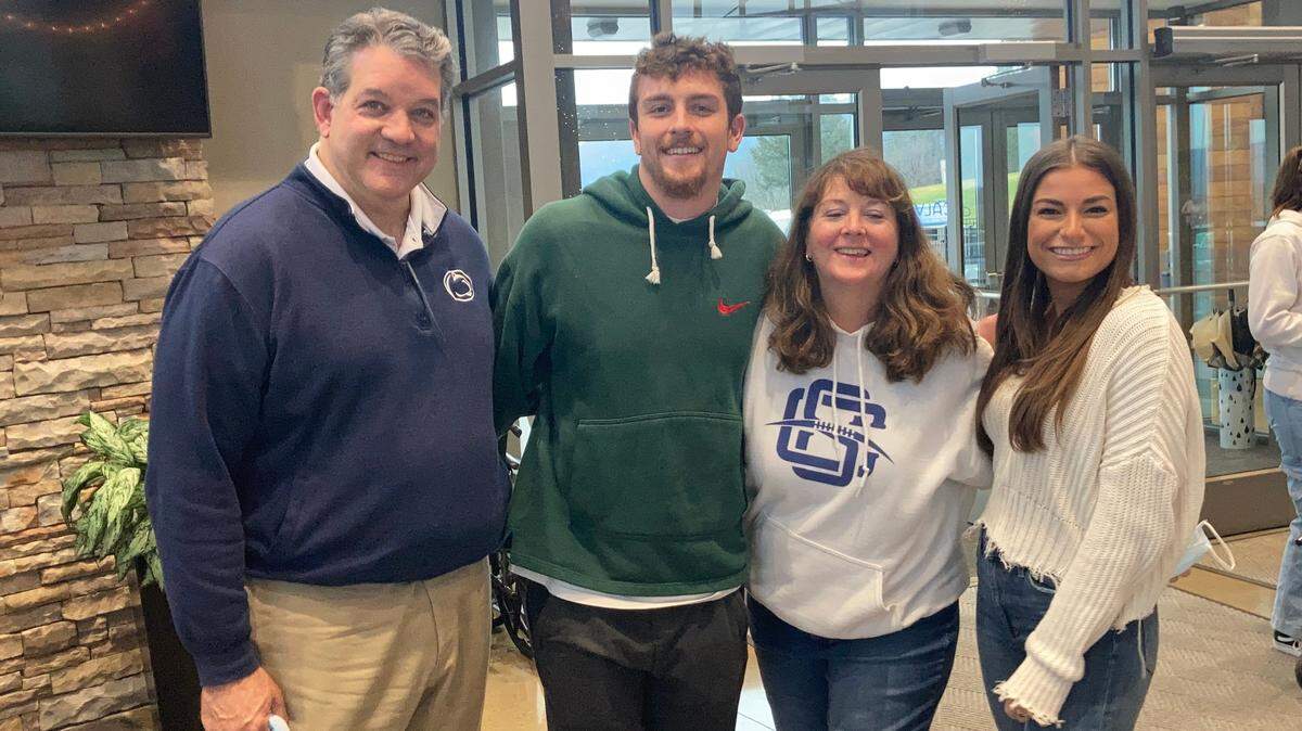Penn State quarterback Sean Clifford (center-left), takes a photo with his father John Clifford (left), mother Kelly Clifford (center-right) and girlfriend Juliana Alessandroni (right) during an event with Big Brothers Big Sisters.