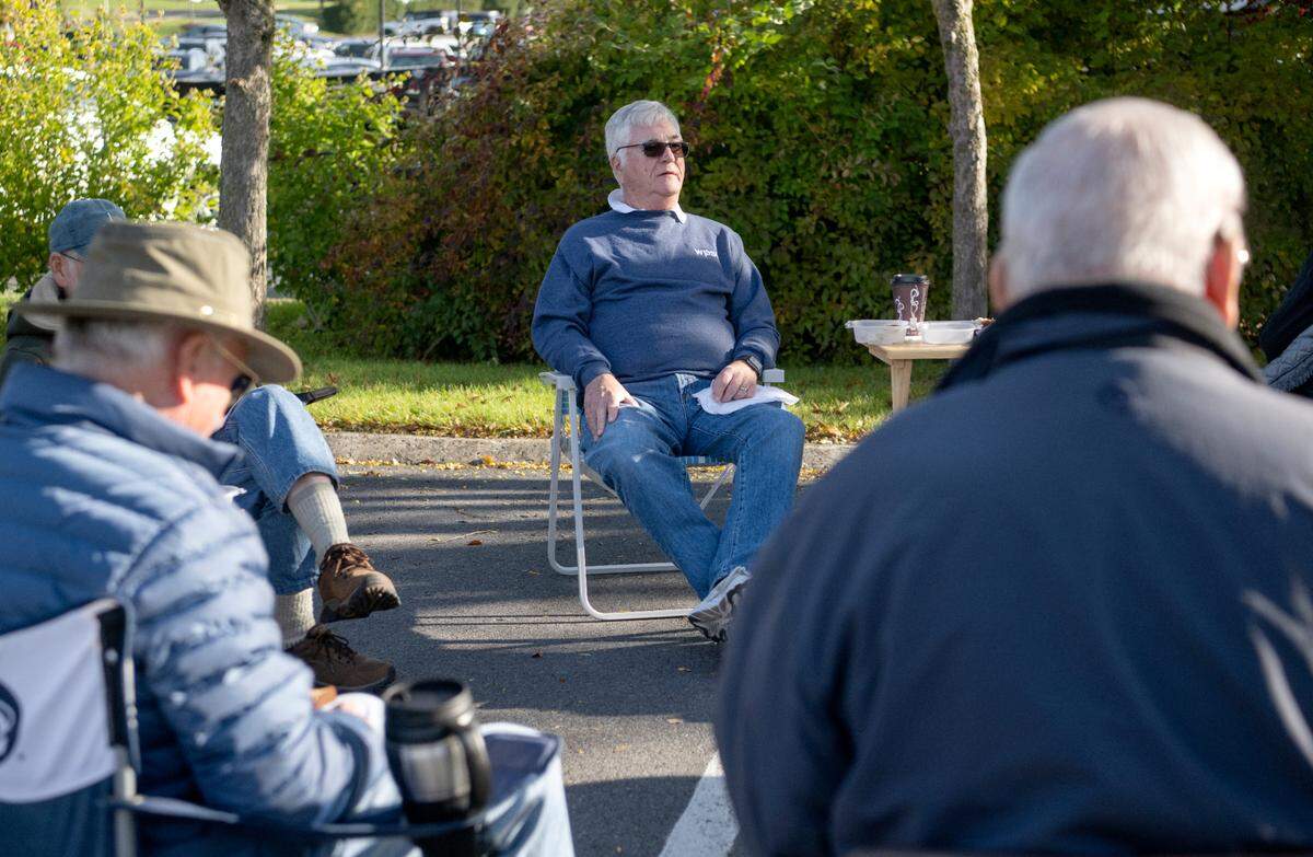 John Casey chats with friends and fellow retired educators Wednesday during a weekly meetup in the parking lot of the Waffle Shop on North Atherton Street.