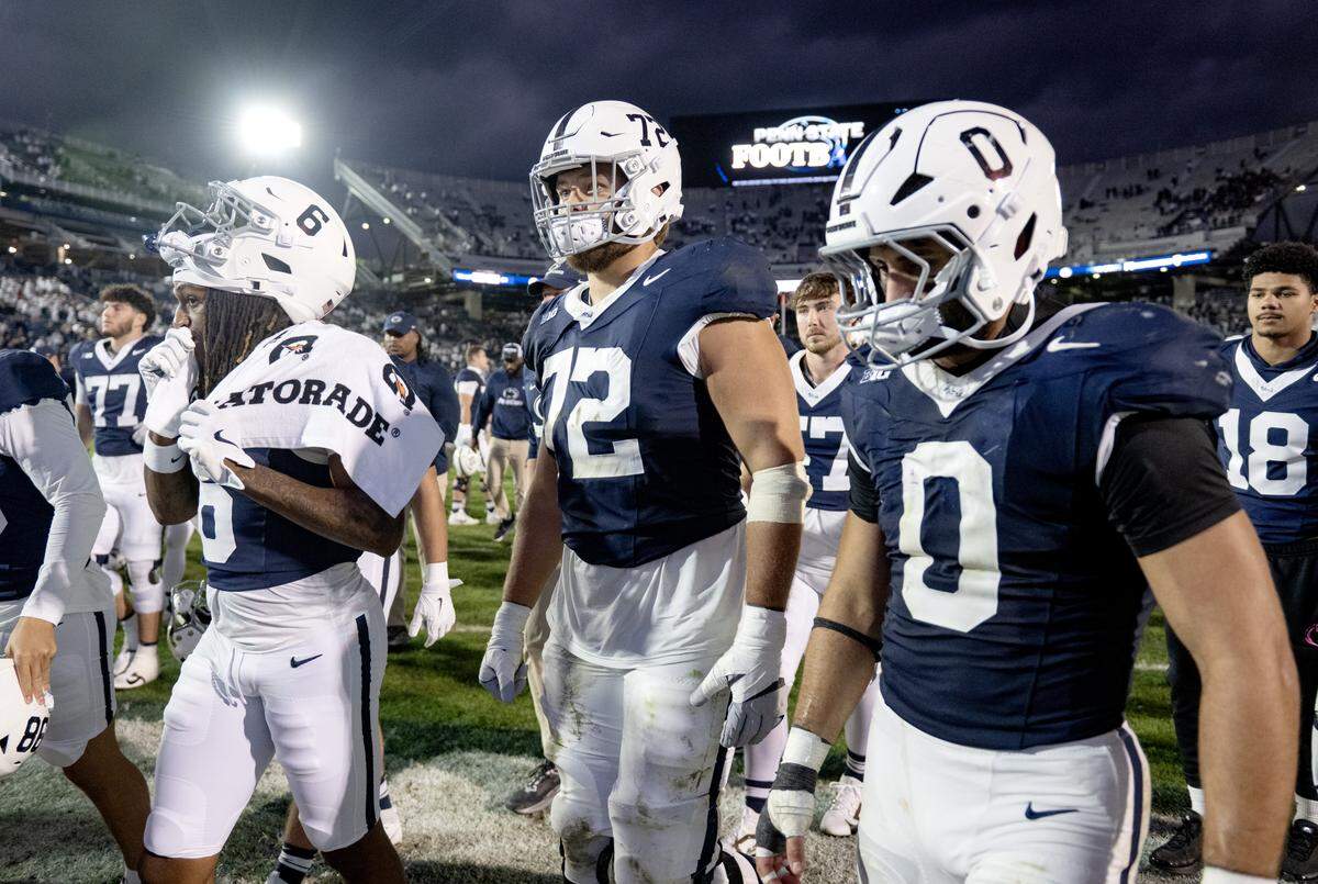 Penn State offensive lineman Nolan Rucci and linebacker Dominic DeLuca walk off the field in disappointment after the loss to Northwestern on Saturday, Oct. 11, 2025.