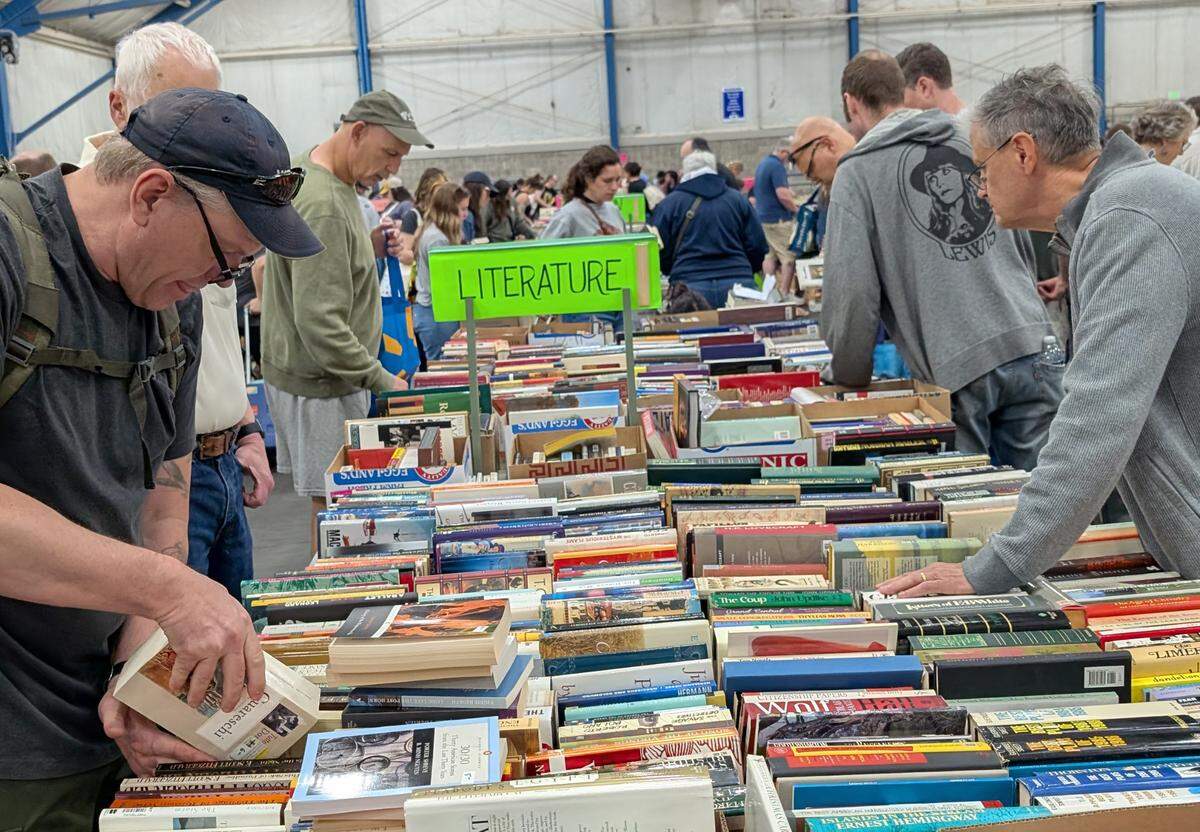 Shoppers browse the literature section at the 2025 AAUW State College Used Book Sale.