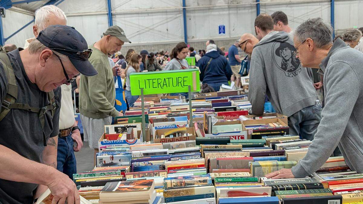 Shoppers browse the literature section at the 2025 AAUW State College Used Book Sale.