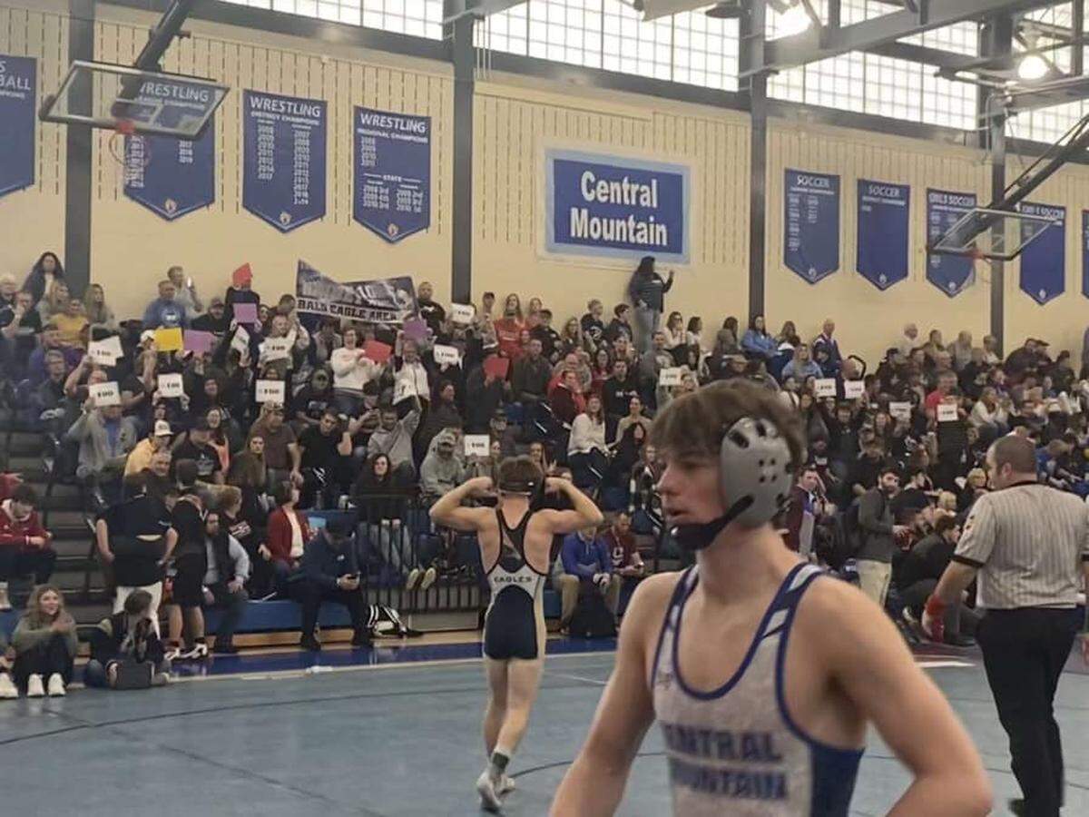 Bald Eagle Area’s Coen Bainey flexes toward the the Eagles’ fans in attendance of the King of the Mountain on Friday. Bainey pinned State College’s Thomas Hill for his 100th career victory.