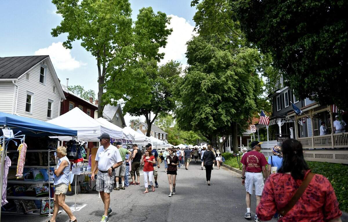 Visitors walk the craft vendors along Main Street during the Memorial Day celebrations in Boalsburg in 2017.