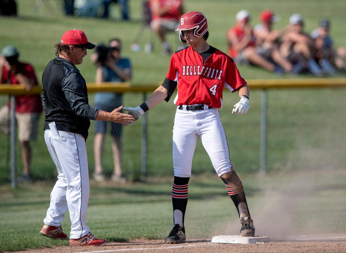 Bellefonte’s Dominic Capperella is congratulated by coachJ Jon Clark after his triple during the District 6 4A championship game against Juanita on Tuesday, May 31, 2022.