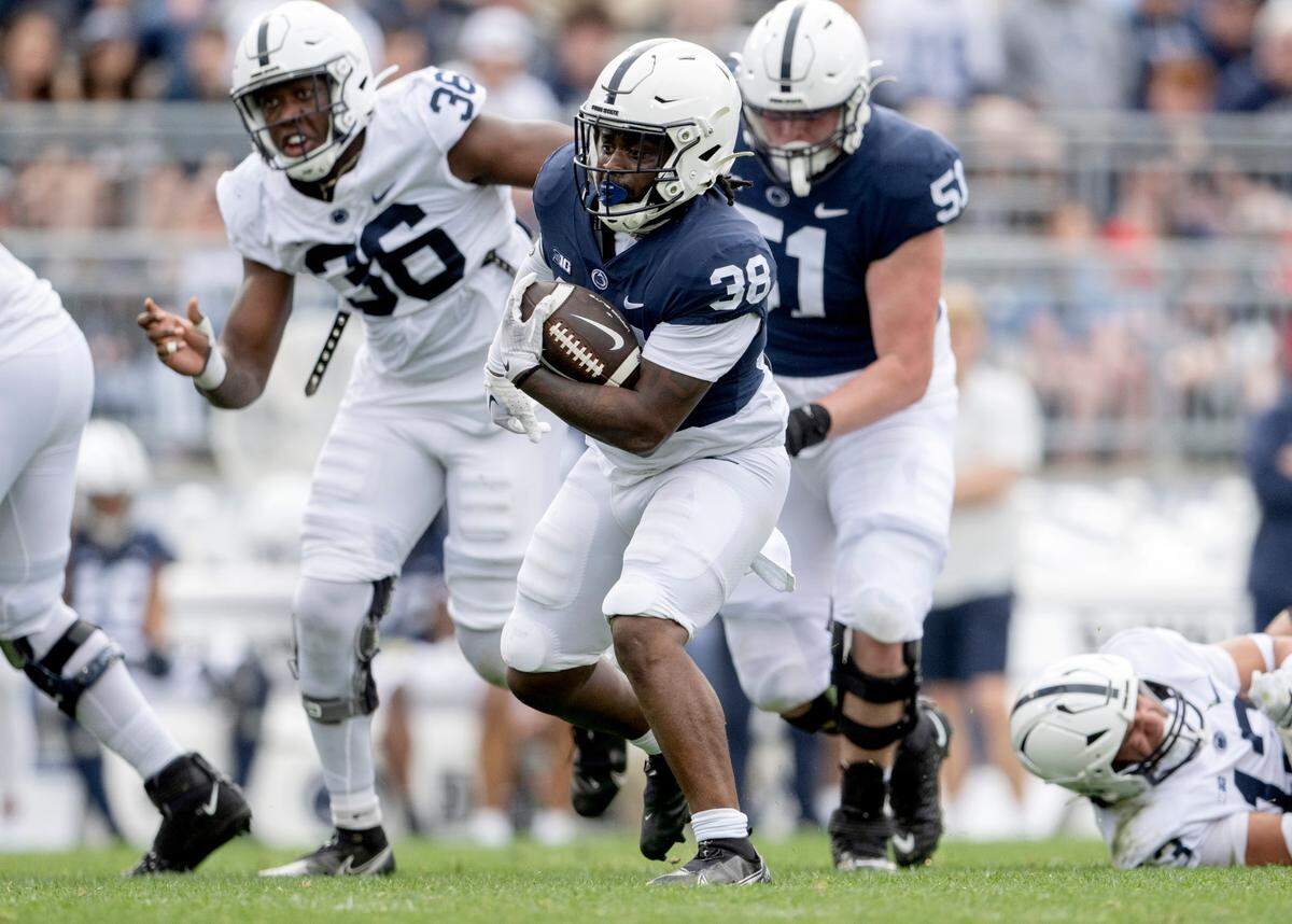 Running back Tank Smith cuts down the field with the ball during the Penn State Blue-White game on Saturday, April 15, 2023.
