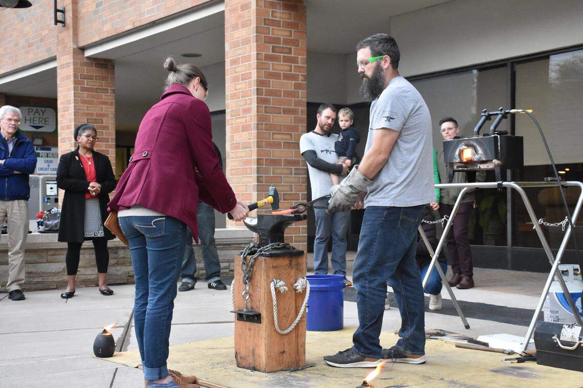 Attendees of the Beating Guns tour in State College were invited to transform the metal of a gun into a gardening tool by hammering the white-hot metal themselves at the forge set up in the Dr. Martin Luther King Jr. Plaza.