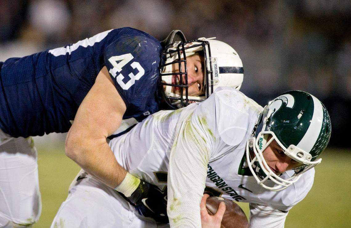 Penn State’s Mike Hull tackles Michigan State’s Connor Cook during the Saturday, November 29, 2014 game at Beaver Stadium. Michigan State won, 34-10.