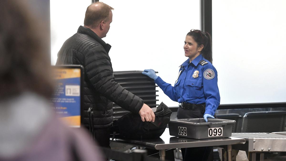 TSA Supervisor Charlene Barrett chats with a passenger at the University Park Airport on Friday, Jan. 11, 2019. TSA workers are considered essential in a federal government shutdown and must work without pay until the shutdown ends.
