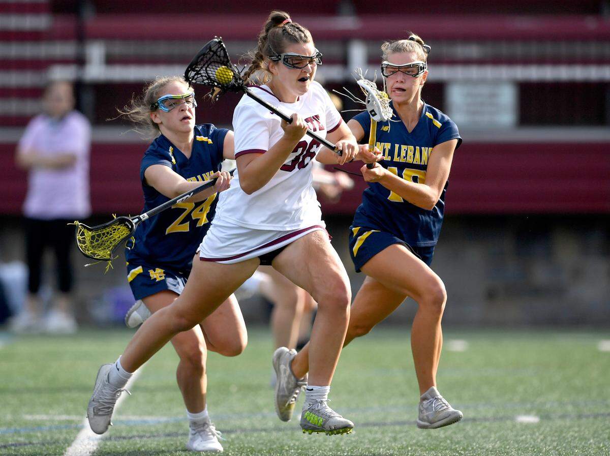 Mt Lebanon defenders try to stop State College’s Lizzie Paterno during the game on Tuesday, June 1, 2021.
