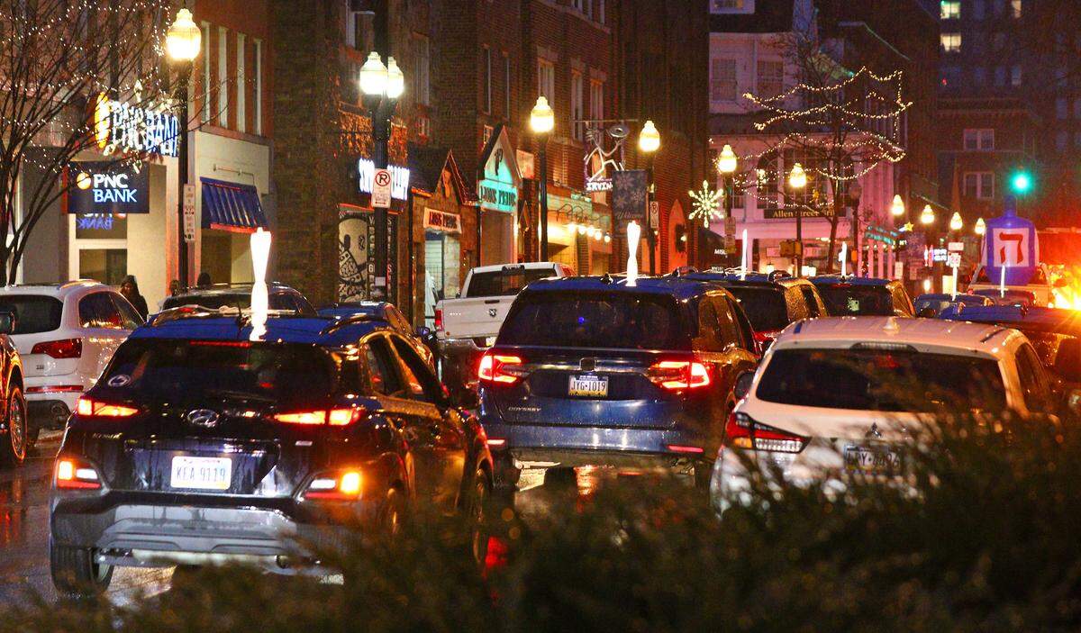 The Menorah Car Parade travels through downtown State College on Sunday before the lighting of a 6 foot tall public Jewish Hanukkah menorah at Old Main.