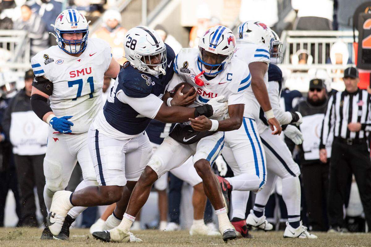 Penn State defensive tackle Zane Durant (28) sacks SMU quarterback Kevin Jennings (7) during the college football playoff game against SMU at Beaver Stadium on Saturday, Dec. 21, 2024.