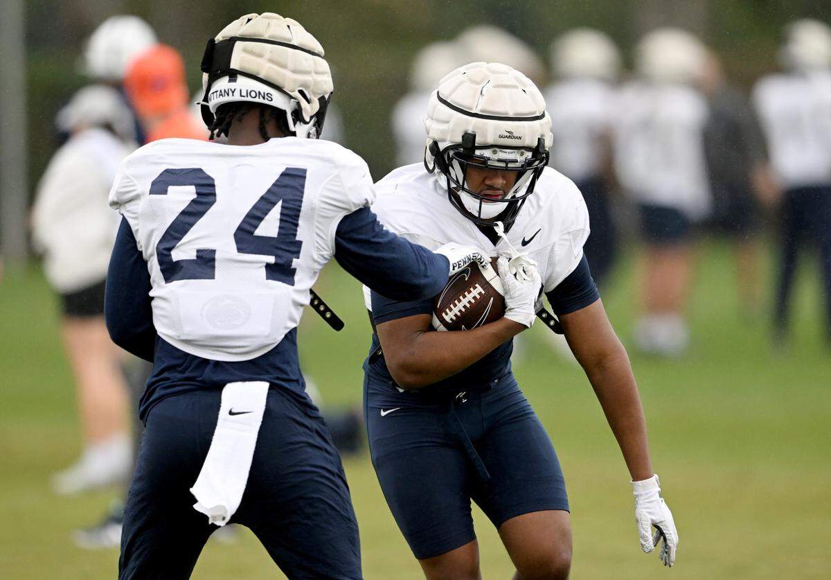 Penn State running back Keyvone Lee tries to knock the ball away from Nick Singleton as they run a drill during practice for the Rose Bowl on Friday, Dec. 30, 2022 at Dignity Health Sports Park.
