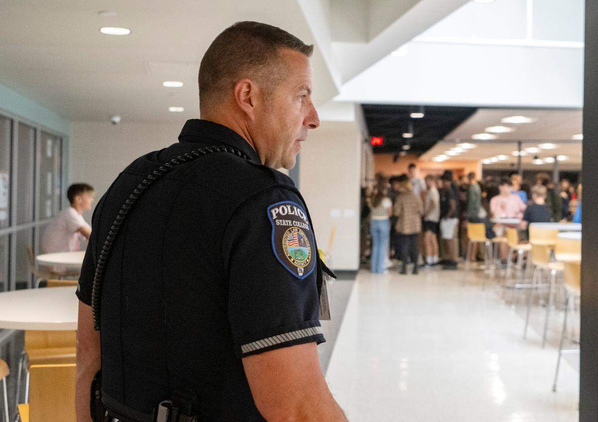 State High school resource officer John Aston walks to the cafeteria as students arrive for lunch on Wednesday, Sept. 14, 2022.
