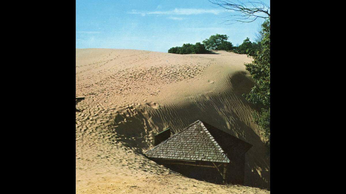 This photo is among the last taken of the Spring House before its roof vanished completely under a sand dune in the early 1960s.