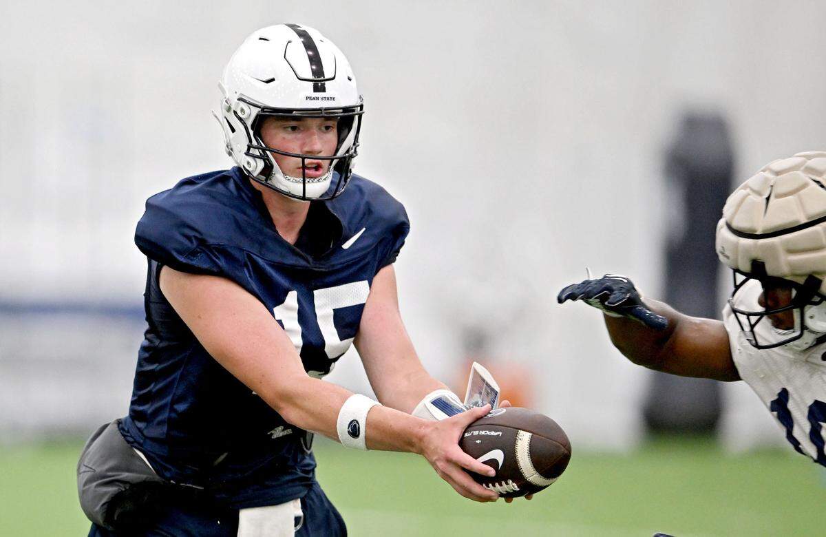 Penn State quarterback Drew Allar hands the ball off during a drill at practice on Saturday, Aug. 3, 2024.