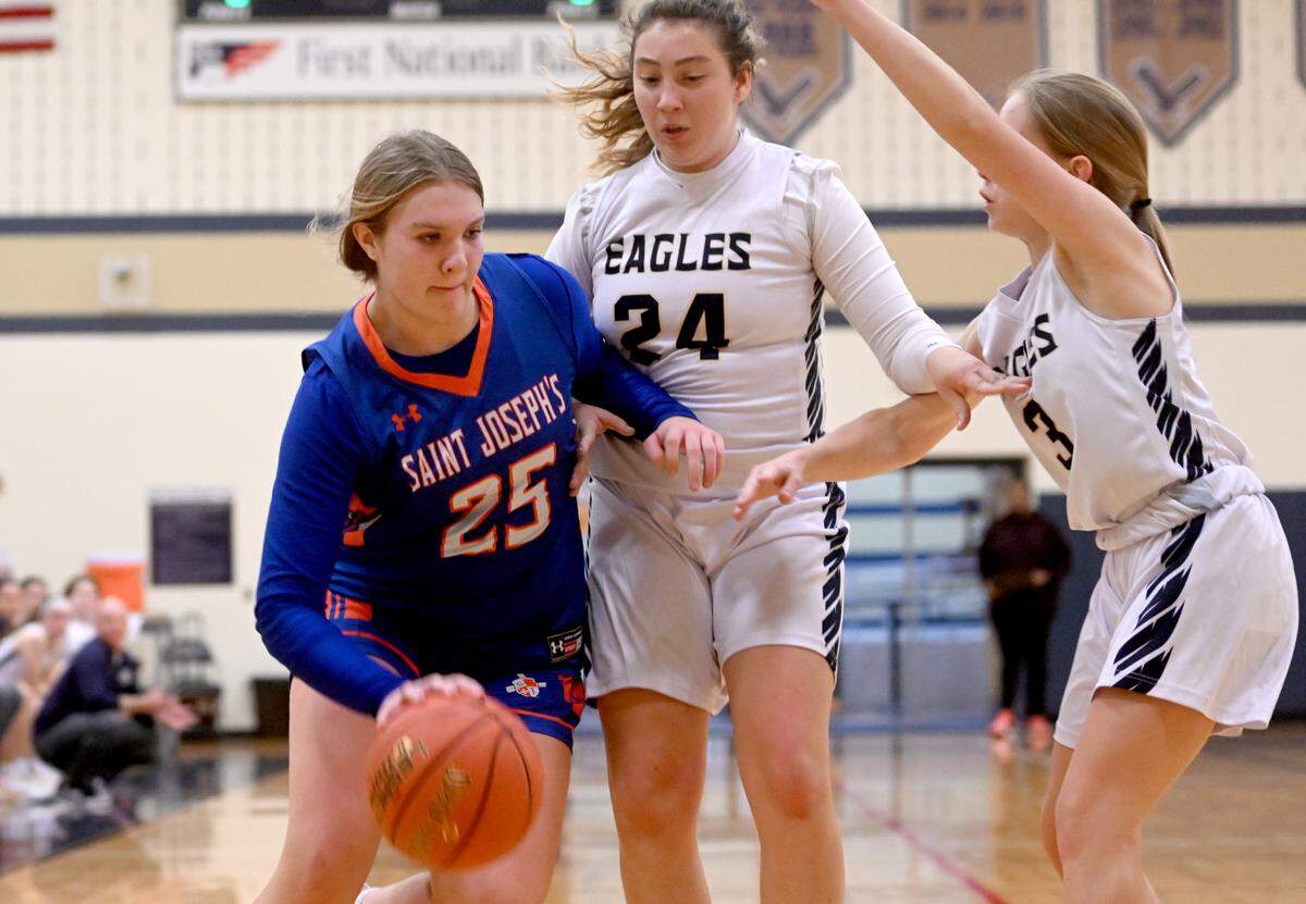 Saint Joseph’s Aubrey Yartz dribbles around Bald Eagle Area defenders during the game on Tuesday, Dec. 6, 2022.