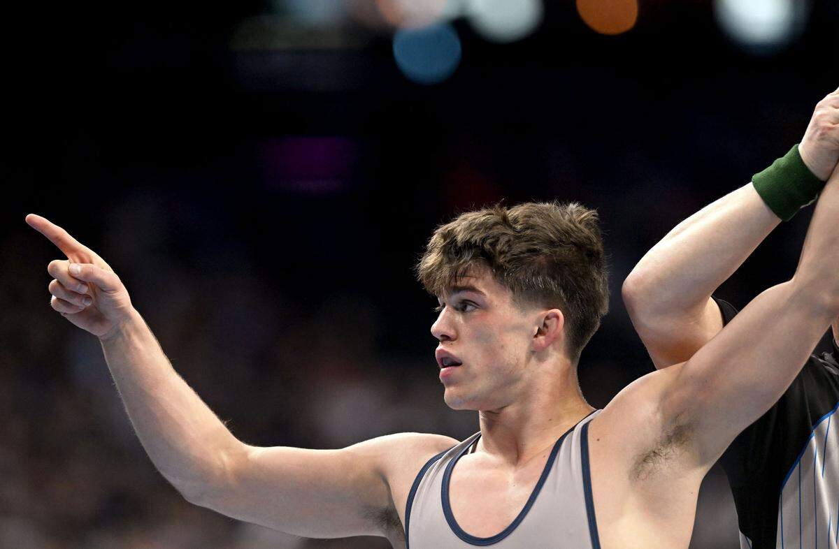 Penn’s Jude Swisher points to fans after his win over Harvard’s James Harrington in a 157-pound bout during the 2025 NCAA Wrestling Championships in Philadelphia on Friday, March 21, 2025.