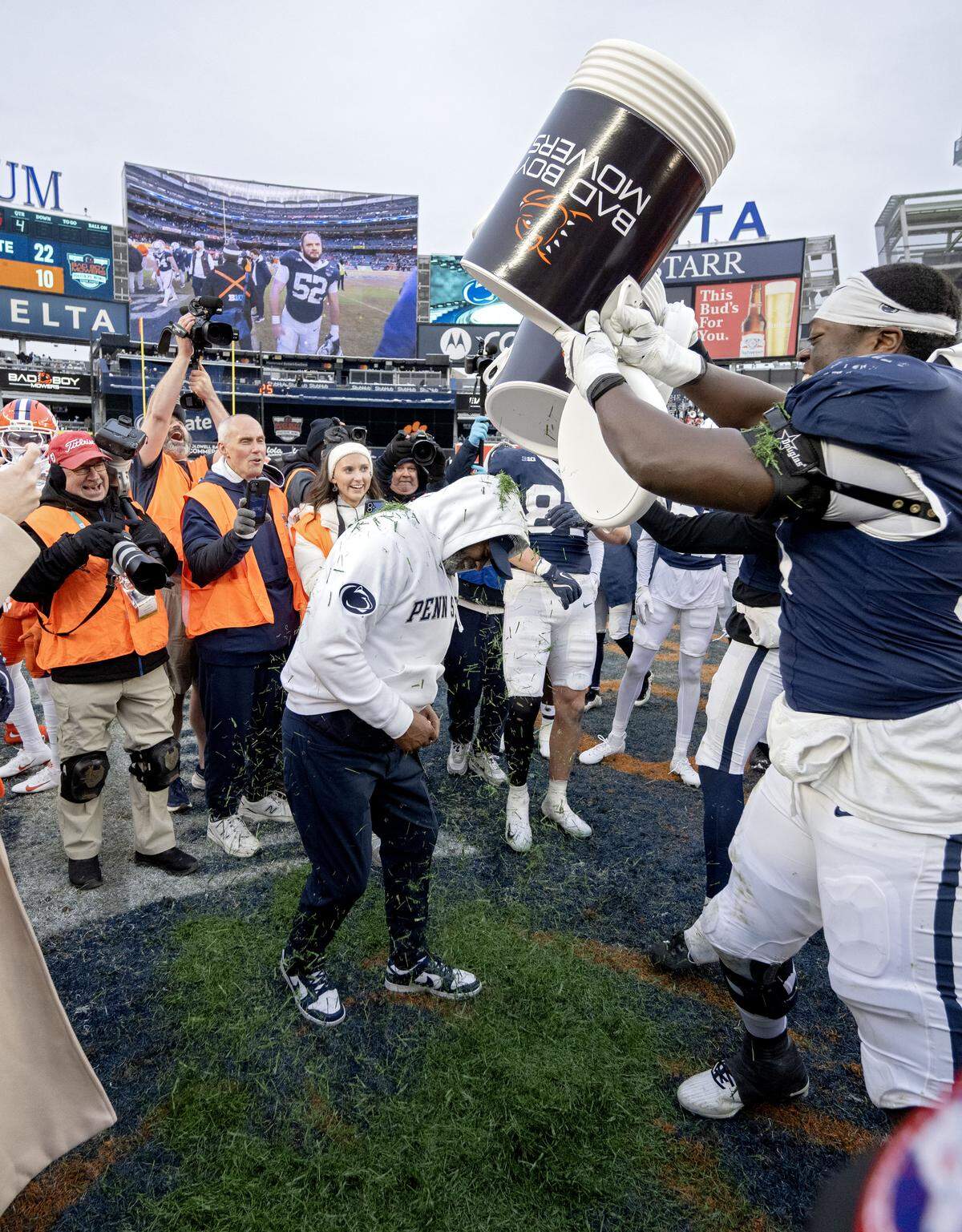 Penn State interim coach Terry Smith gets a cooler of grass dumped on him by cornerback Zion Tracy and offensive lineman Anthony Donkoh after the win over Clemson in the Pinstripe Bowl at Yankee Stadium on Saturday, Dec. 27, 2025.