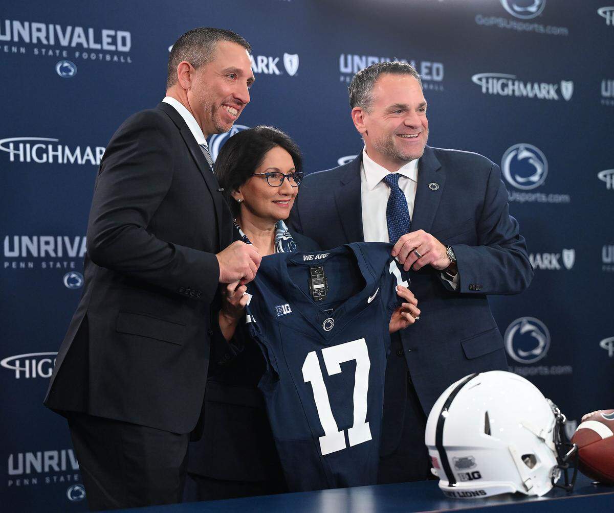 Penn State football head coach Matt Campbell, left, is a presented a Nittany Lions football jersey by university President Neeli Bendapudi, center, and Penn State Athletics Director Pat Kraft during his introduction at Beaver Stadium on Monday, Dec. 8, 2025.