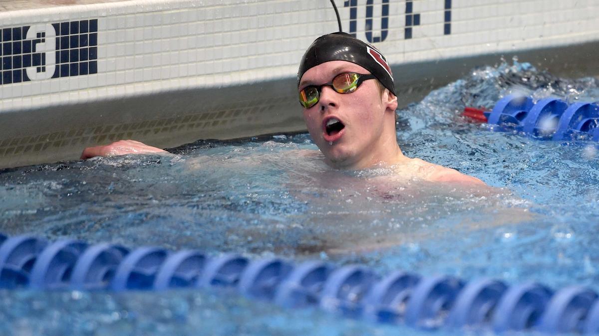 State College’s Matt Brownstead smiles as he looks to the time board after winning the 50 freestyle during the District 6 swimming championships on Friday, March 1, 2019 at the Penn State Natatorium.