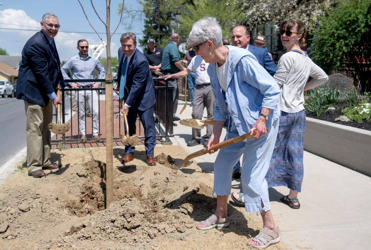 Sue Smith, chair of the Lemont Village Association, along with elected officials, plant a tree along Pike Street as part of the Pike Street traffic calming and streetscape dedication ceremony on Friday, April 21, 2023.