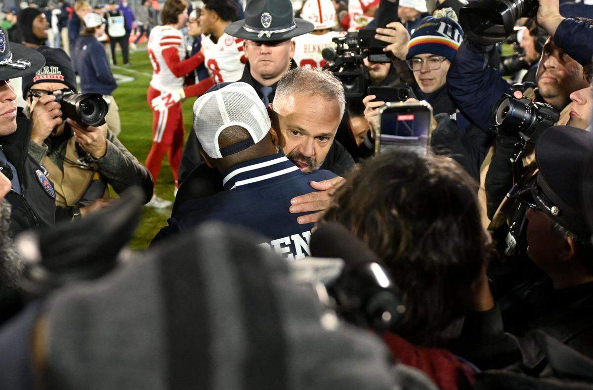 Nebraska football coach Matt Rhule hugs Penn State interim coach Terry Smith after the game on Saturday, Nov. 22, 2025, at Beaver Stadium.  