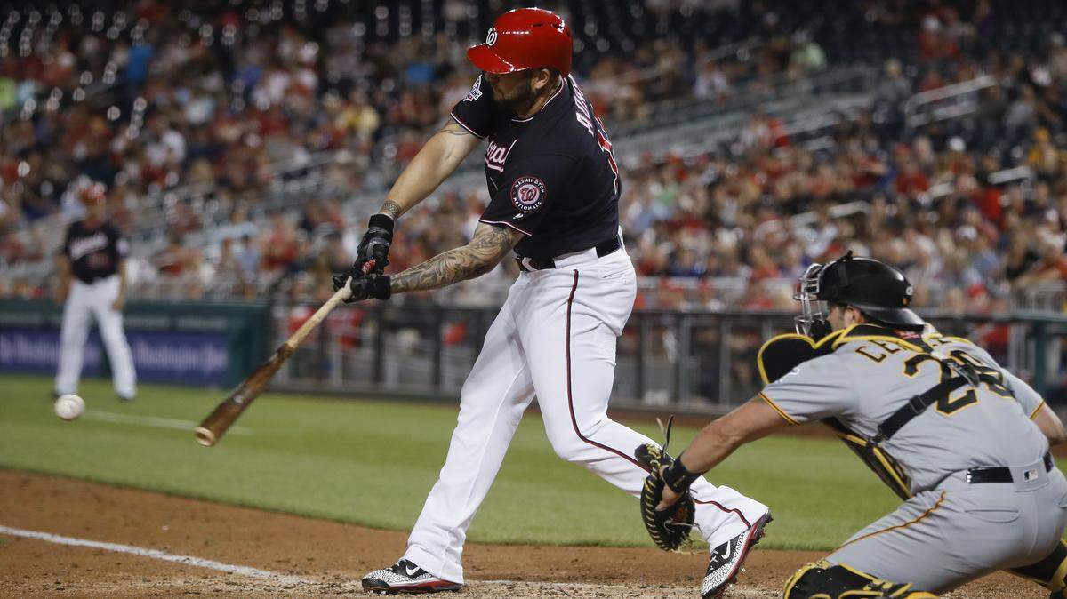 Washington Nationals' Matt Adams (15) hits an RBI single against the Pittsburgh Pirates during the sixth inning of a baseball game at Nationals Park, Tuesday, May 1, 2018, in Washington. Behind the plate is Pirates catcher Francisco Cervelli.