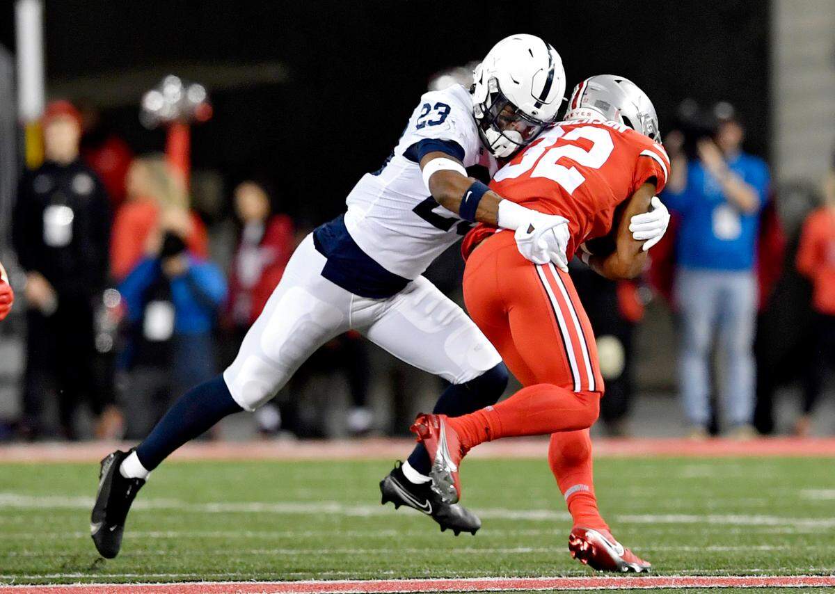Penn State linebacker Curtis Jacobs stops Ohio State running back TreVeyon Henderson during the game on Saturday, Oct. 30, 2021 at Ohio Stadium.