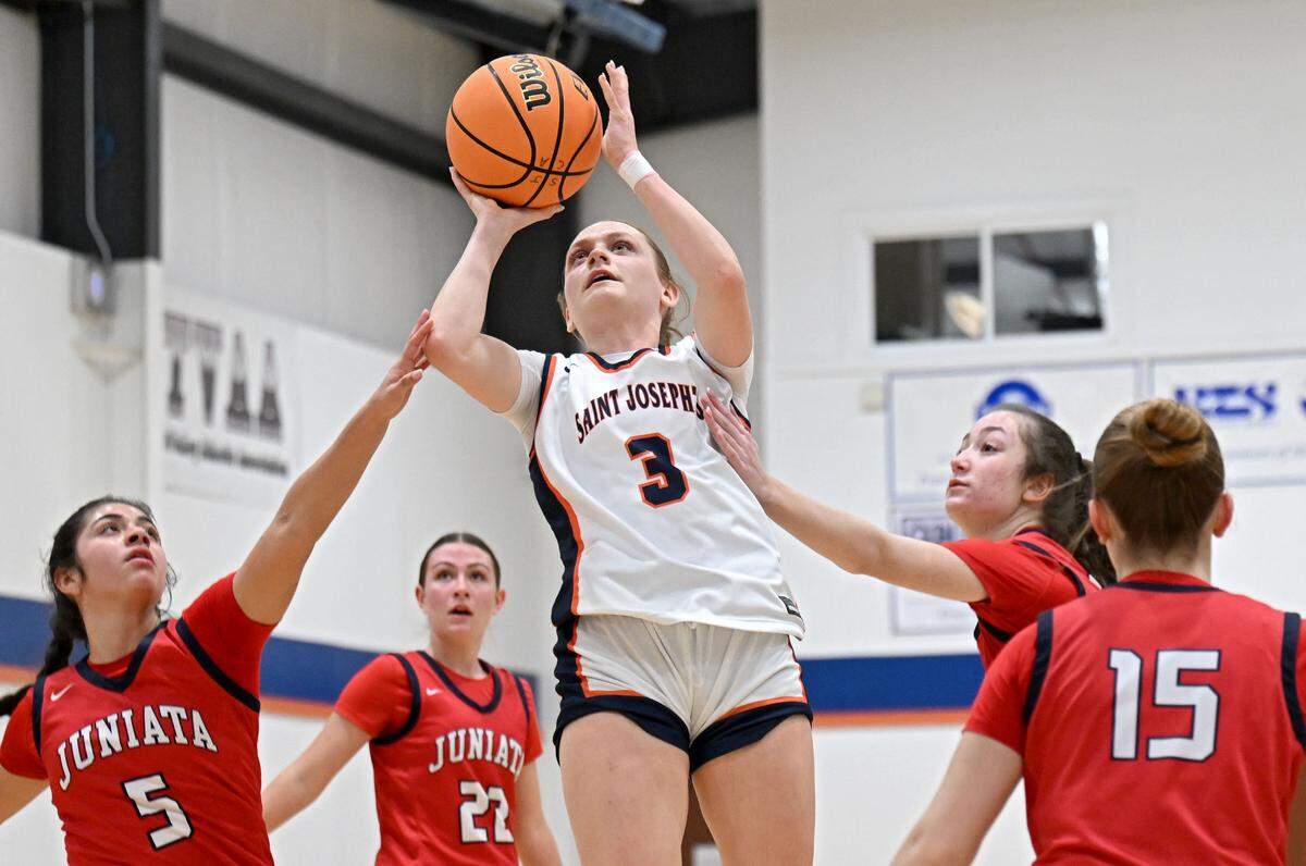 Saint Joseph’s Catholic Academy’s Naomi Crispin gets her 2,000th point over Juniata defenders during the game on Monday, Feb. 9, 2026.