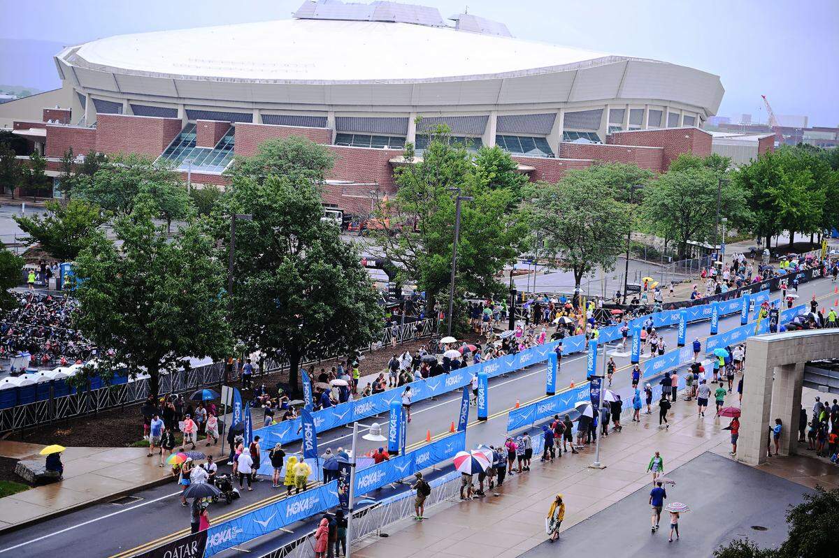 Participants in the Ironman 70.3 Pennsylvania Happy Valley run the chute leading to the finish line inside Beaver Stadium on Sunday, July 2, 2023.