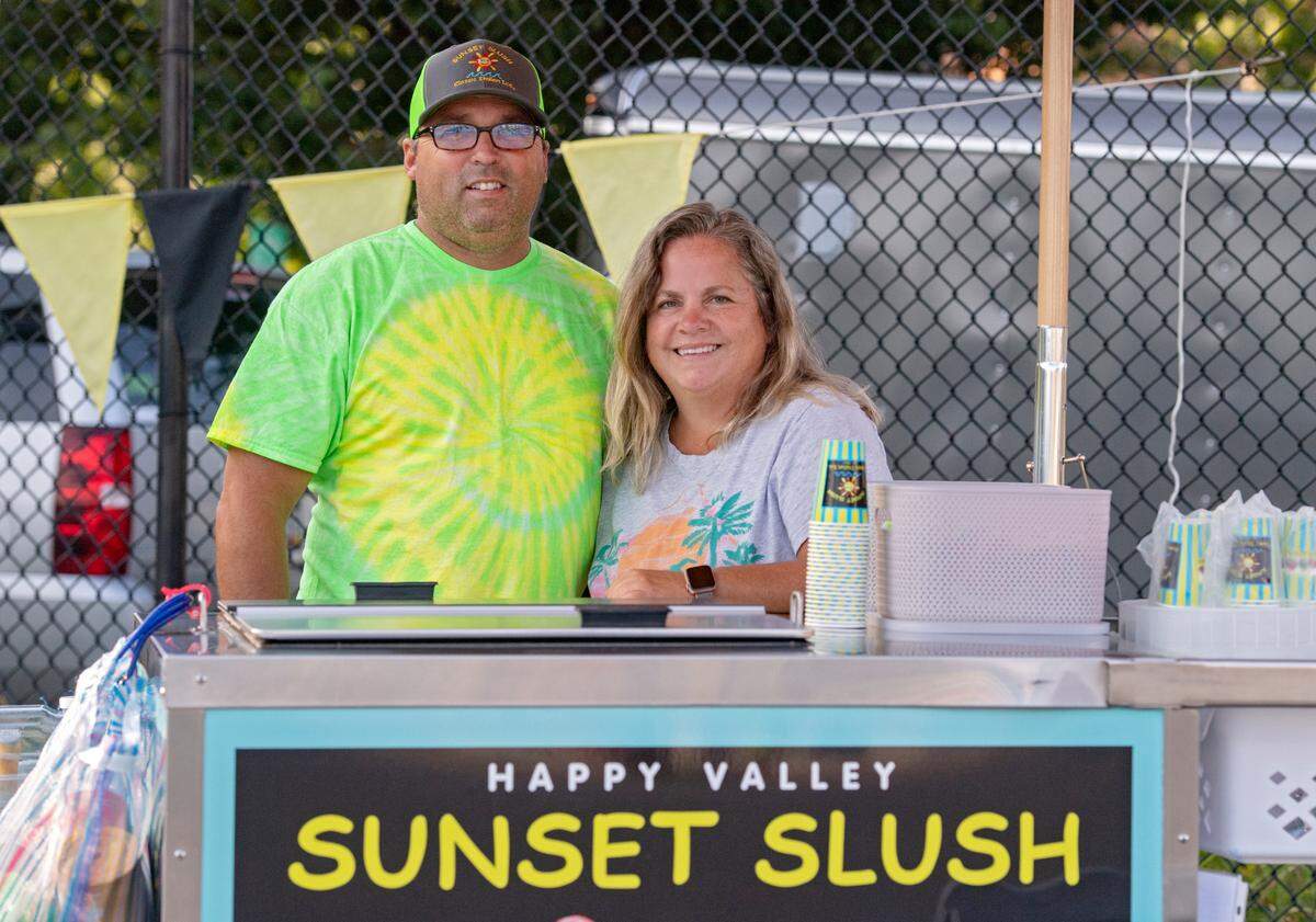Turtle and Lee Ann Patterson at their Sunset Slush Happy Valley stand at Welch Pool on Wednesday.