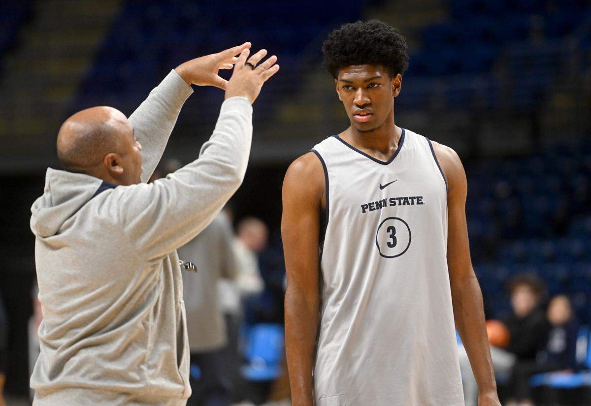Penn State men’s basketball coach Micah Shrewsberry goes over a technique with freshman Kebba Njie during practice on Tuesday, Oct. 25, 2022.