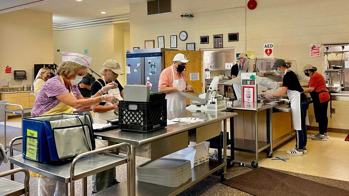 Volunteers for State College Area Meals on Wheels prepare and package meals on Monday at Grace Lutheran Church. The nonprofit organization is celebrating its 50th year serving community members.