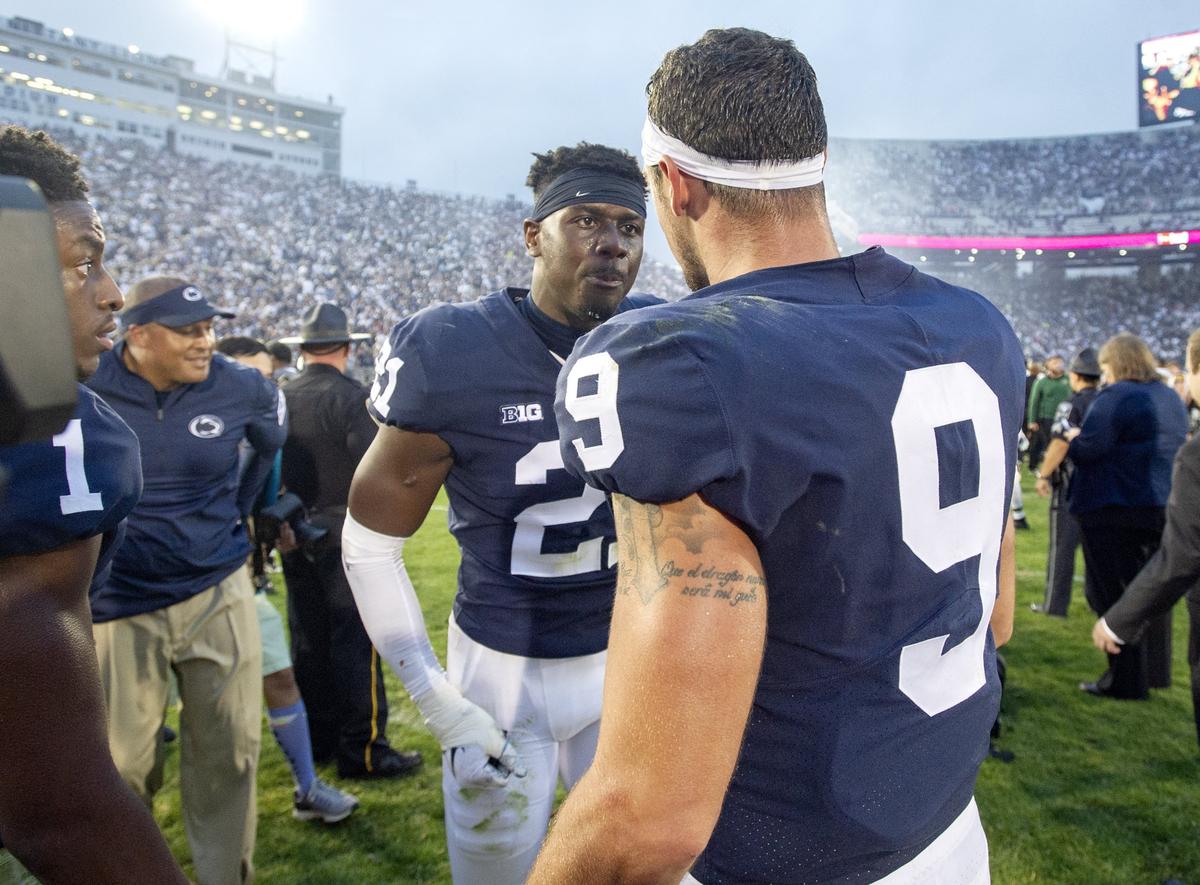 Penn State quarterback Trace McSorley congratulates cornerback Amani Oruwariye for his interception to beat Appalachian State in overtime Saturday, Sept. 1, 2018 game at Beaver Stadium.