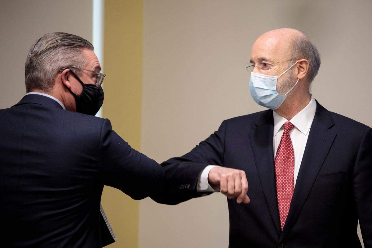 In January 2021, Al Schmidt bumped elbows with Democratic Gov. Tom Wolf after speaking out against efforts to overturn Pennsylvania’s presidential election results.