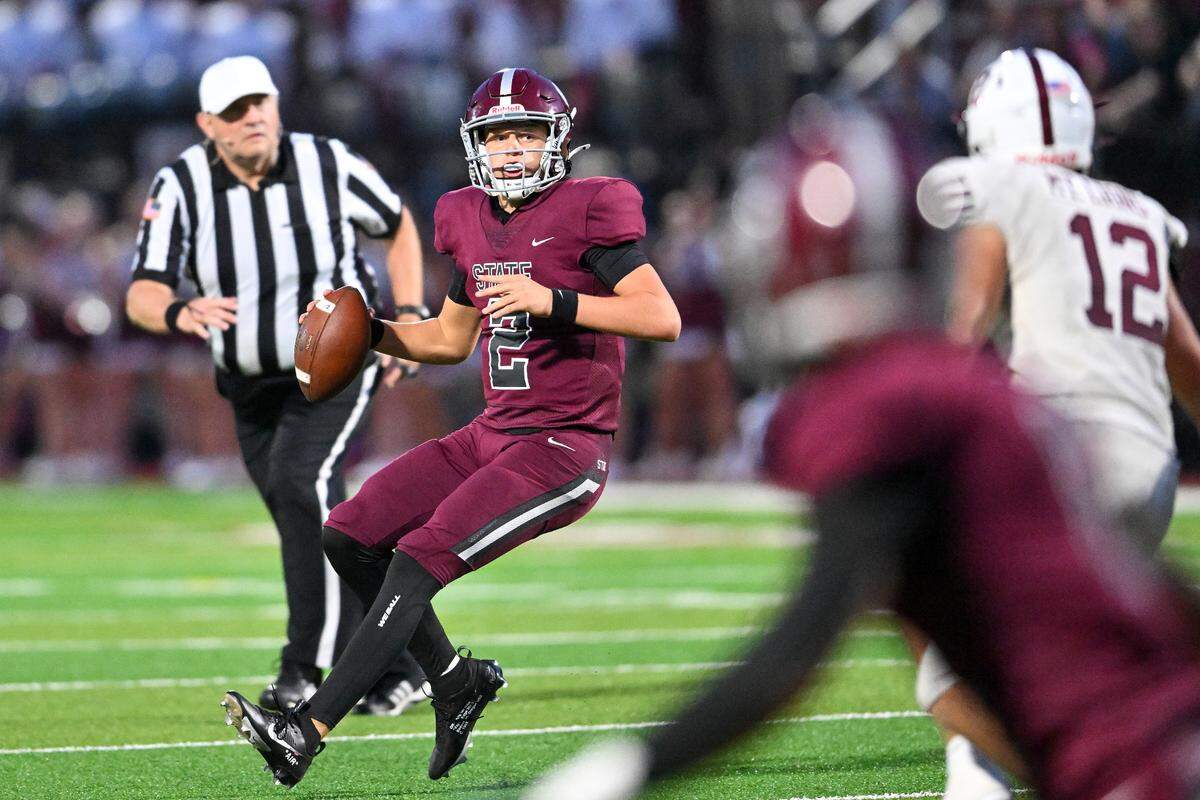 Quaterback Eddie Corkery rolls out wide looking for his receiver down field in State College’s home opener against Altoona on Friday, Aug. 30, 2024.