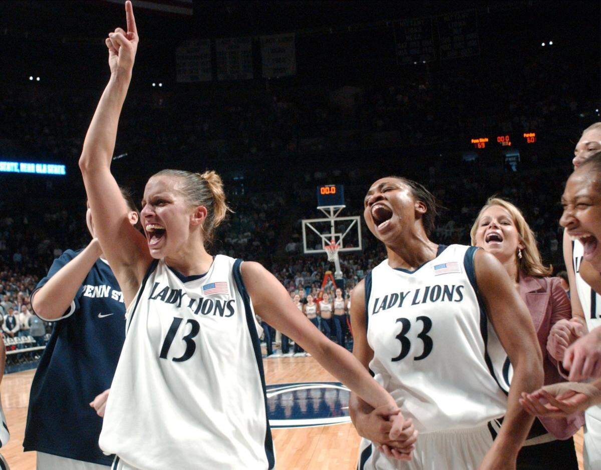 Penn State's  Kelly Mazzante (13) and Tanisha Wright (33) celebrate their 69-60 win over Purdue to capture the Big 10 Regular Season Championship on Feb. 29, 2004.
