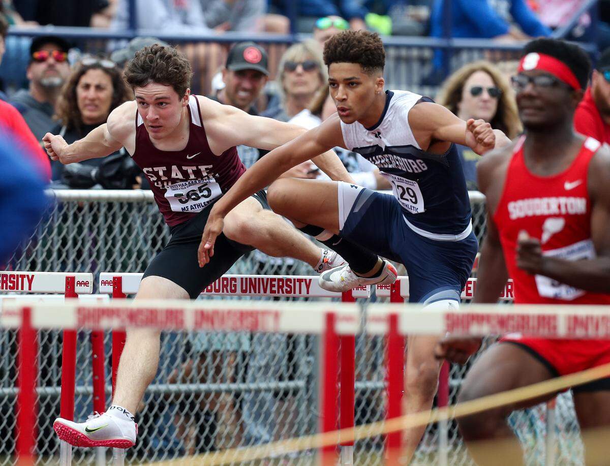 State College’s John Sicree, left, competes against Chambersburg’s Darion Baumgartner, right, in the boys Class 2A 110 meter hurdles preliminaries during the PIAA State Track and Field Championships held Friday at Seth Grove Stadium on the Shippensburg University campus in Shippensburg.