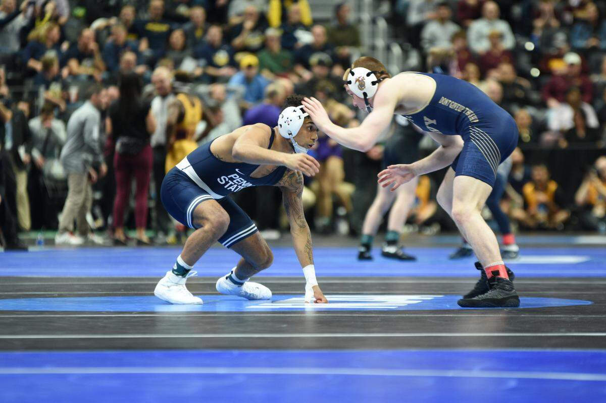 Penn State’s Roman Bravo-Young looks for a shot attempt on Navy’s Josh Koderhandt in their 133-pound second round match of the NCAA Championships on Thursday, March 17, 2022 at Little Caesars Arena in Detroit. Bravo-Young pinned Koderhandt in 4:45.