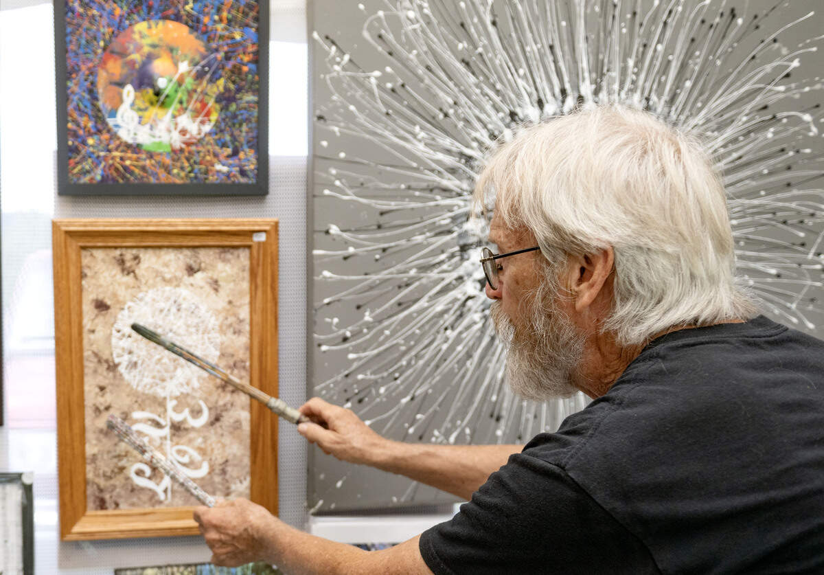 Georgie LeHoop shows how he uses drumsticks and drumming to create his painting at the People’s Choice Festival on Thursday, July 9, 2026.