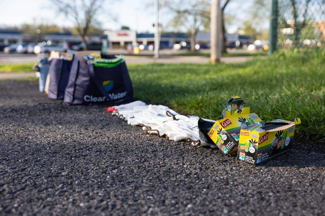 Gloves, trash bags and vests are laid out for volunteers at the entrance of a community park off Westerly Parkway in State College, Pa., on Saturday, April 18, 2026. The ClearWater Conservancy organized volunteers across Centre County to collect trash from public green spaces.