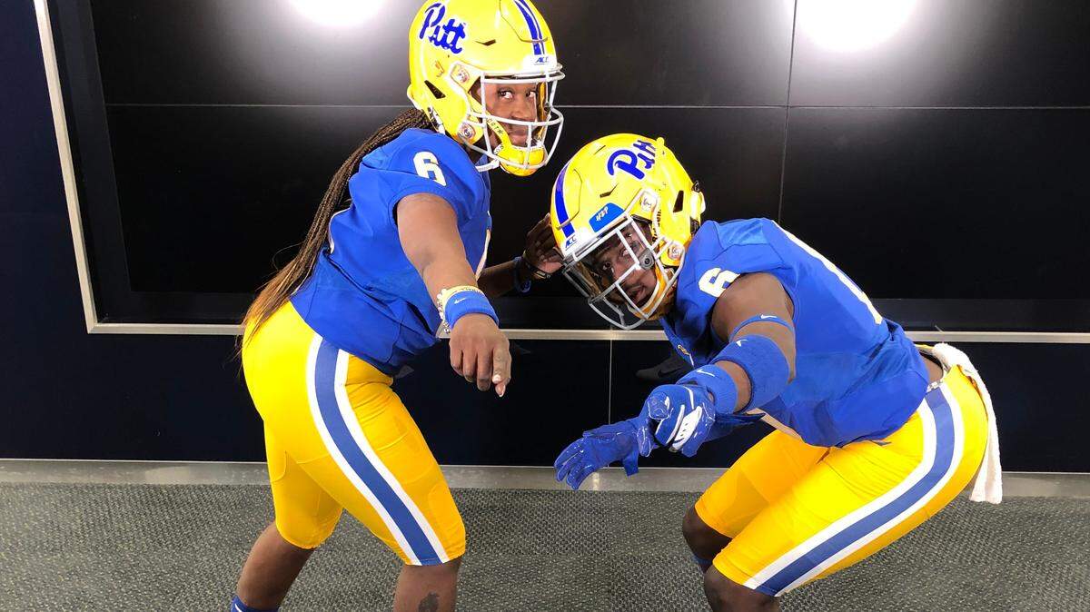 In a photo provided by University of Pittsburgh Athletics, Leslie Smith, right, and his mother Lucretia Chapple pose for a photo at an official visit to the University of Pittsburgh, where he has since signed. The Smiths are part of a growing trend of parents who like to pose with their children in college signing photos.