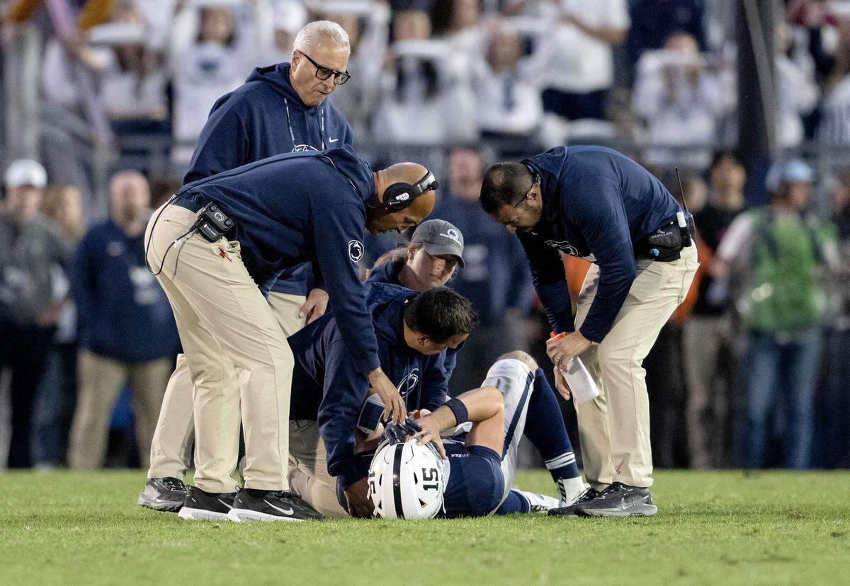 Dr. Wayne Sebastianelli, trainers and Penn State football coach James Franklin attend to quarterback Drew Allar when he went down after a play during the game against Northwestern on Saturday, Oct. 11, 2025.