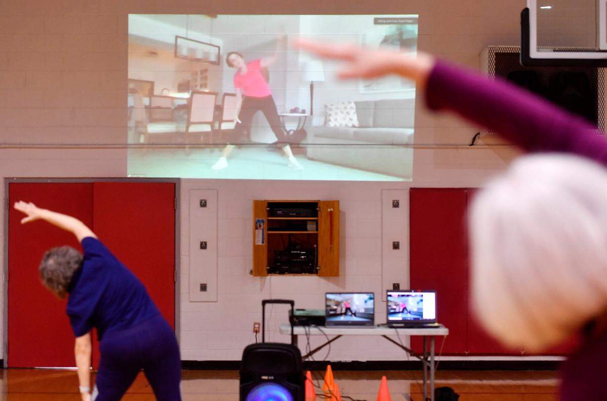 YMCA members follow along with Sue Rogacs Friday in the active adult total fitness class. The class can be taken virtually or in person.