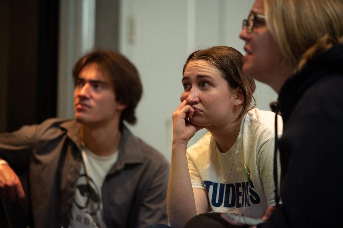 Dejected students watch the 2024 presidential race live on television Tuesday night during a Democratic watch party in downtown State College. 